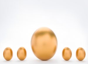Investment Concept With Large And Small Golden Eggs