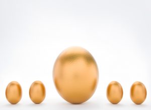 Investment Concept With Large And Small Golden Eggs